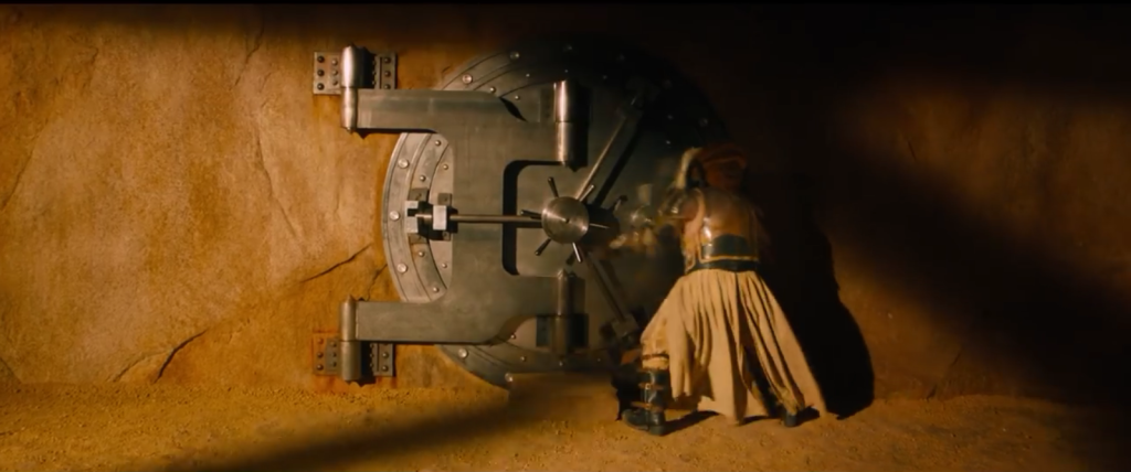 Immortan Joe opens the bank vault door he uses to lock up his "brides" (read: women that he forcibly imprisons, sexually assaults, and impregnates so that he can have children)